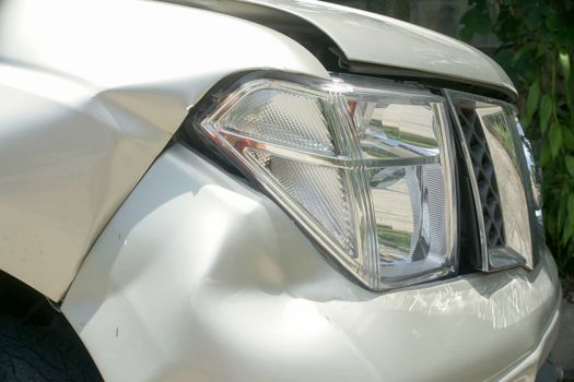 A dent on the right front of a pickup truck (damage from crash accident)