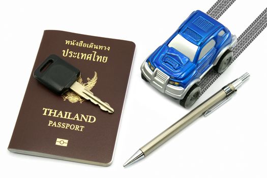 Thailand passport, key, pen and blue 4wd car for travel concept.
