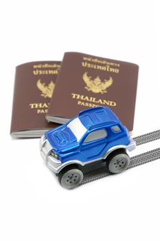 Thailand passport and blue 4wd car for travel concept.