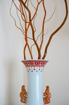 White vase with tree twigs