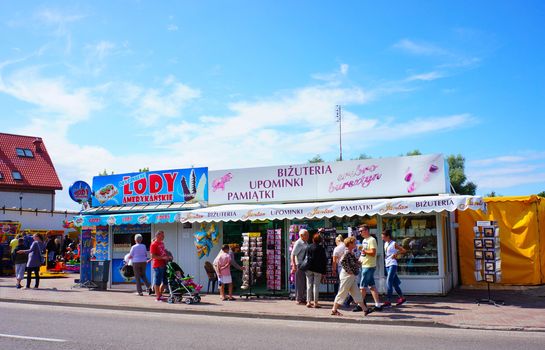 USTRONIE MORSKIE, POLAND - JULY 20, 2015: People by a American ice cream counter and souvenir shop