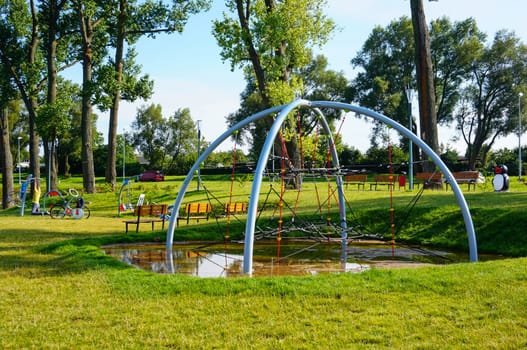 Climbing ropes on green grass at a play ground