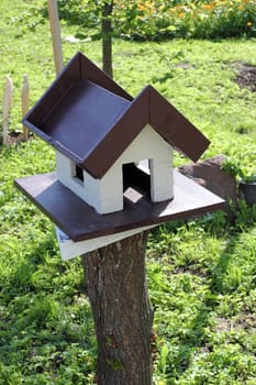 House for the birds painted in gray with brown