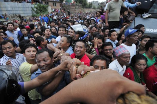 NEPAL, Lalitpur: Hindu and Buddhist devotees celebrate Bunga Dyah Jatra, more commonly known in Nepal as Rato Machhendranath, on September 23, 2015 in Laltipur, Nepal. The festival is celebrated by pulling a chariot through the Nakhu River.   Rato Machhendranathis is known as the god of rain to both Hindu and Buddhist worshippers, who hope the celebration will bring enough rain to prevent droughts during the rice plantation season.   