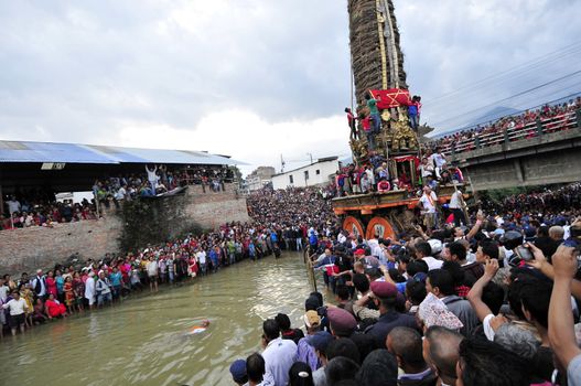 NEPAL, Lalitpur: Hindu and Buddhist devotees celebrate Bunga Dyah Jatra, more commonly known in Nepal as Rato Machhendranath, on September 23, 2015 in Laltipur, Nepal. The festival is celebrated by pulling a chariot through the Nakhu River.   Rato Machhendranathis is known as the god of rain to both Hindu and Buddhist worshippers, who hope the celebration will bring enough rain to prevent droughts during the rice plantation season.   