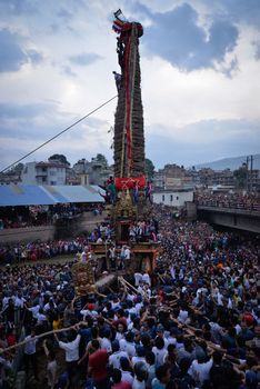 NEPAL, Patan: Hindus and Buddhists gather around the chariot of Rato Machhindranath as it is pulled along a river in Patan, Lalitpur, Nepal, on September 23, 2015. 