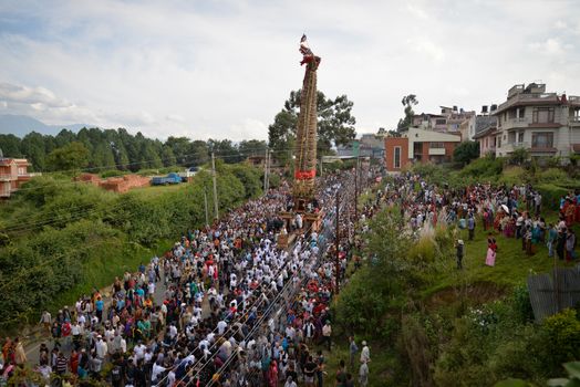 NEPAL, Patan: Hindus and Buddhists gather around the chariot of Rato Machhindranath as it is pulled along a river in Patan, Lalitpur, Nepal, on September 23, 2015. 