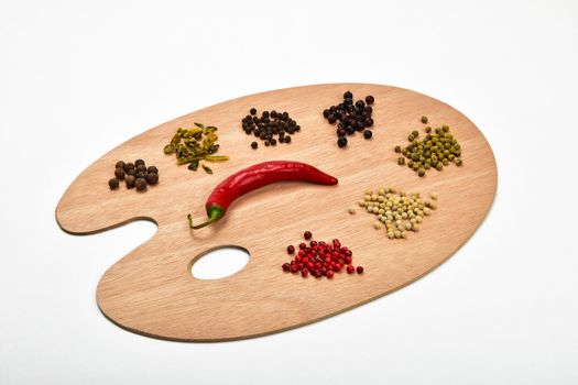 Palette of spices, collection of various spices on wooden palette isolated on white