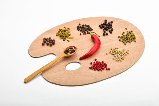 Palette of spices, collection of various spices on wooden palette isolated on white