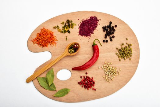 Palette of spices, collection of various spices on wooden palette isolated on white