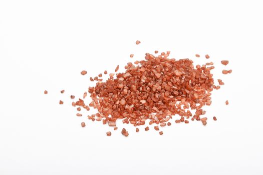 Handful of red Hawaiian sea salt isolated on white background