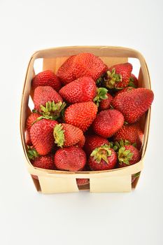 Mellow fresh summer strawberries in wooden basket isolated on white background