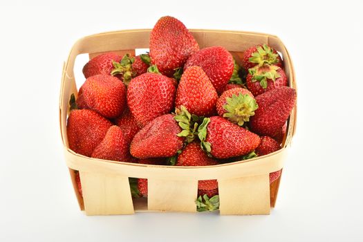 Mellow fresh summer strawberries in wooden basket isolated on white background
