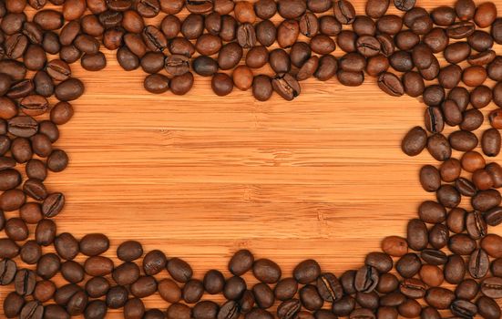 Roasted Arabica coffee espresso beans shape solid border frame over wooden bamboo board background