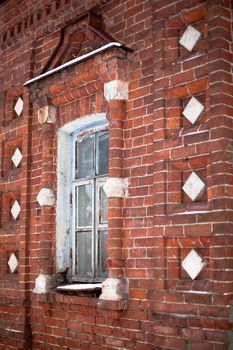 Red old brick building with window
