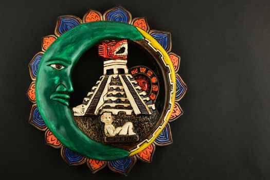 Mexican Mayan Chichen Itza souvenir ceramic painted plate with Moon, pyramid and girl isolated on black paper