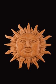 Mexican traditional Mayan culture wooden carved sun symbol plate isolated on black