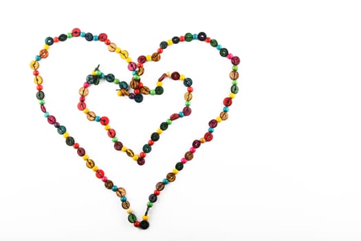 Double heart shaped colorful handmade wooden round beads necklace isolated on white