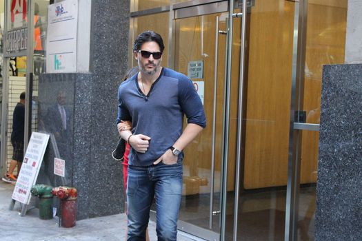 USA, New York: TV star Joe Manganiello heads to his car after visiting Ron Ben-Israel Cakes in Midtown Manhattan with superstar fiancee Sofia Vergara (behind) on September 23, 2015. Bakery staff confirmed that the super couple was at the shop; but when asked if the pair had decided to buy their wedding cake from the bakery, one employee revealed that it was all up in the air.