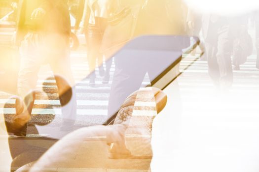 Double exposure of using smart phone and people walking on street background
