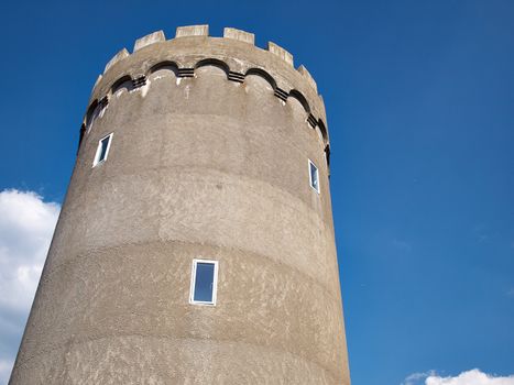 Old concrete city water tower with clear blue sky background