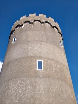 Old concrete city water tower with clear blue sky background vertical image