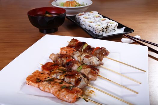 Japanese cooking skewers, sushi, soup and vegetables