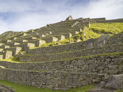 The Watchman's Hut on the top of Terraced Fields in the upper Agricultural Sector in a pre-Columbian 15th-century Inca site of the lost Inca city Machu Picchu, Andes mountains, Urubamba, Cusco, Peru.