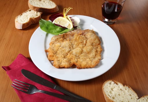 plate with breaded cutlet and vegetables