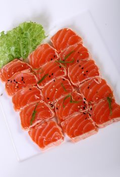 Japanese cuisine carpaccio of raw salmon with lettuce leaf