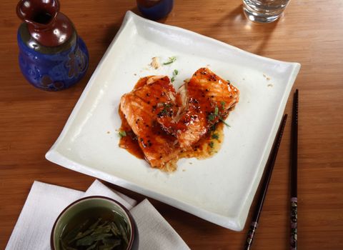 Japanese cuisine salmon fillet on white plate