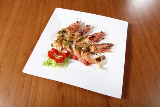 shrimp dish cooked on plate with vegetables