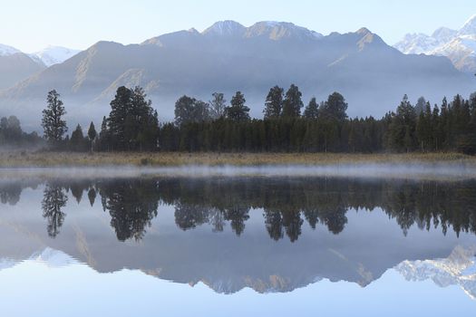 Reflection of Lake Matheson with Mount Cook and Mount Tasman as background, West Coast region, South Island, New Zealand.