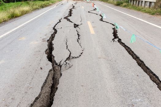 Asphalt road cracked and broken from earthquake.