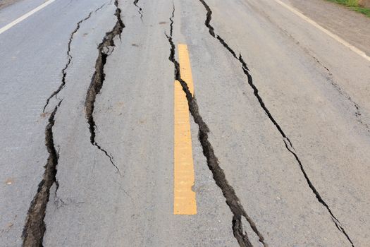 Asphalt road cracked and broken from earthquake.