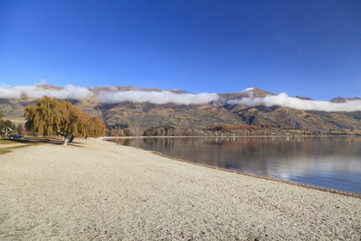 Beautiful View of Lake Wanaka and its beach in autumn, Otago region, South Island, New Zealand.