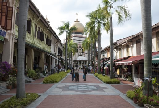 SINGAPORE - MARCH 8, 2007: Unknown children and adults shopping in the street near the Sultans mosk in Singapore on march 8 2007