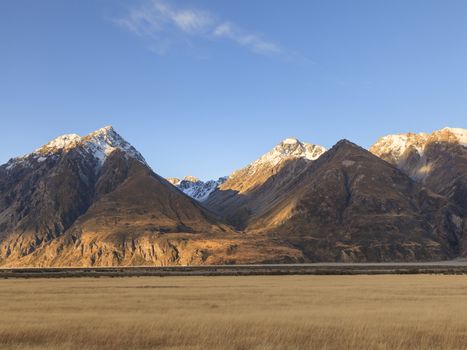 Colorful countryside of dried grassland valley and mountains near Mt.Cook road, Aoraki Mount Cook valley, South Island, New Zealand.