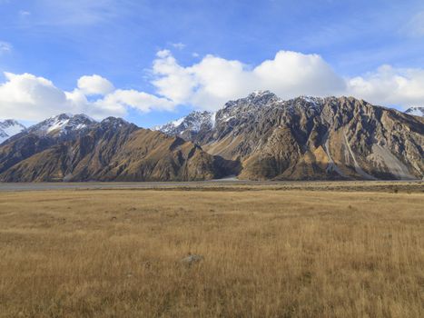 Colorful countryside of tussock valley and mountains near Mt.Cook road, Aoraki Mount Cook valley, South Island, New Zealand.