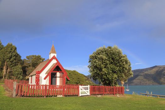 Beautiful ancient Maori church under the rainbow in Akaroa, New Zealand