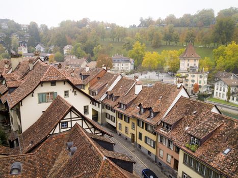 View of Bern or Berne, the capital city of Switzerland in the autumn morning mist. In 1983 the historic old town in the centre of Bern became a UNESCO World Heritage Site.