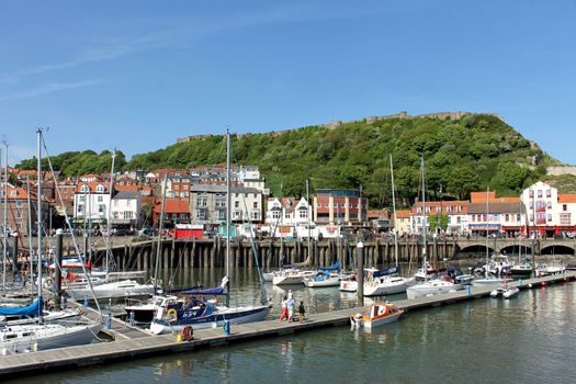 SCARBOROUGH, NORTH YORKSHIRE, ENGLAND - 19th May 2014: Scarborough town and harbor seaside resort on the 19th of May 2014. This is a popular tourist destination every summer, particularly from visitors from European countries.