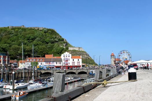 SCARBOROUGH, NORTH YORKSHIRE, ENGLAND - 19th May 2014: Scarborough town and harbor seaside resort on the 19th of May 2014. This is a popular tourist destination every summer, particularly from visitors from European countries.