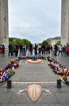 Paris, France - May 14, 2015: Tourist visit Tomb of the Unknown Soldier beneath the Arc de Triomphe, Paris. on May 14, 2015.