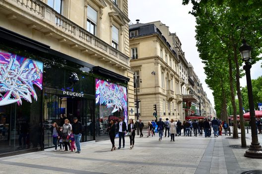 Paris, France - May 14, 2015: Local and tourists on the Avenue des Champs-elysees on May 14, 2015.The Avenue is one of the most famous streets in the world for upscale shopping.