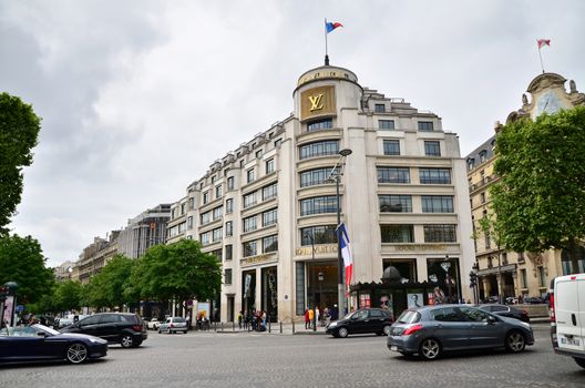 Paris, France - May 14, 2015: Tourists Shopping at Louis Vuitton store on May 14, 2015 in Paris, France. This store is located on the Champs Elyses and offers a wide range of luxury Louis Vuitton clothes and accessories