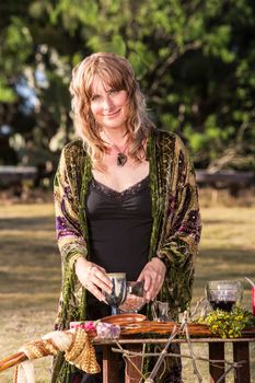 Smiling adult in outdoor pagan ritual practice
