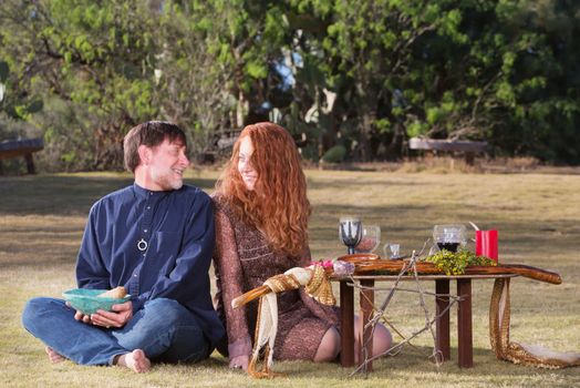 Happy pagan couple at altar with woodland pentagram