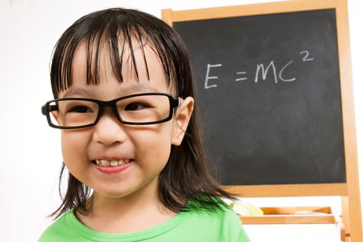 Asian Chinese children againts blackboard or chalkboard with formulas in plain isolated white background.