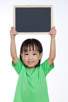 Asian Chinese children holding balckboard in plain isolated white background.